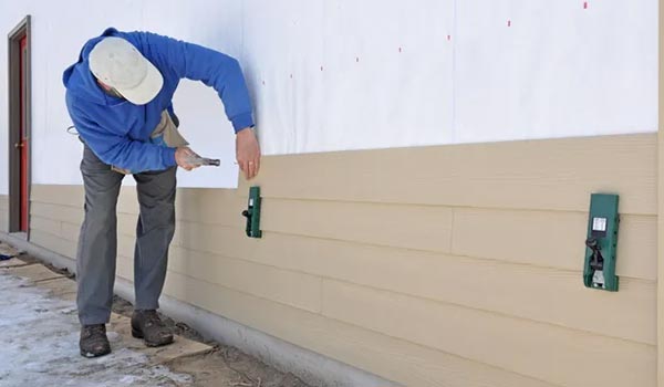 man installing siding