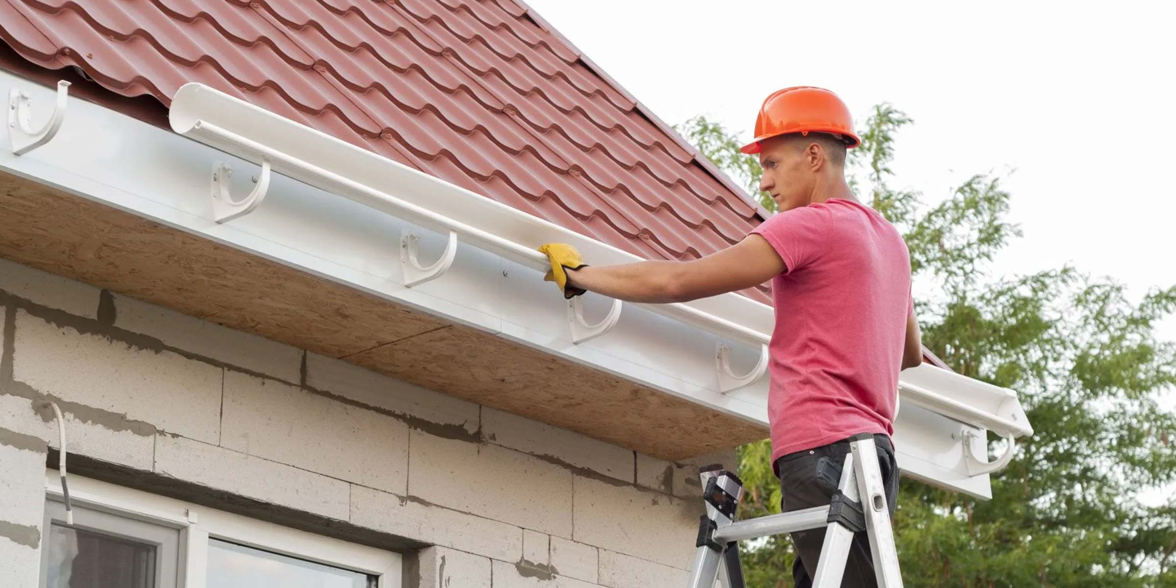 man installing gutters