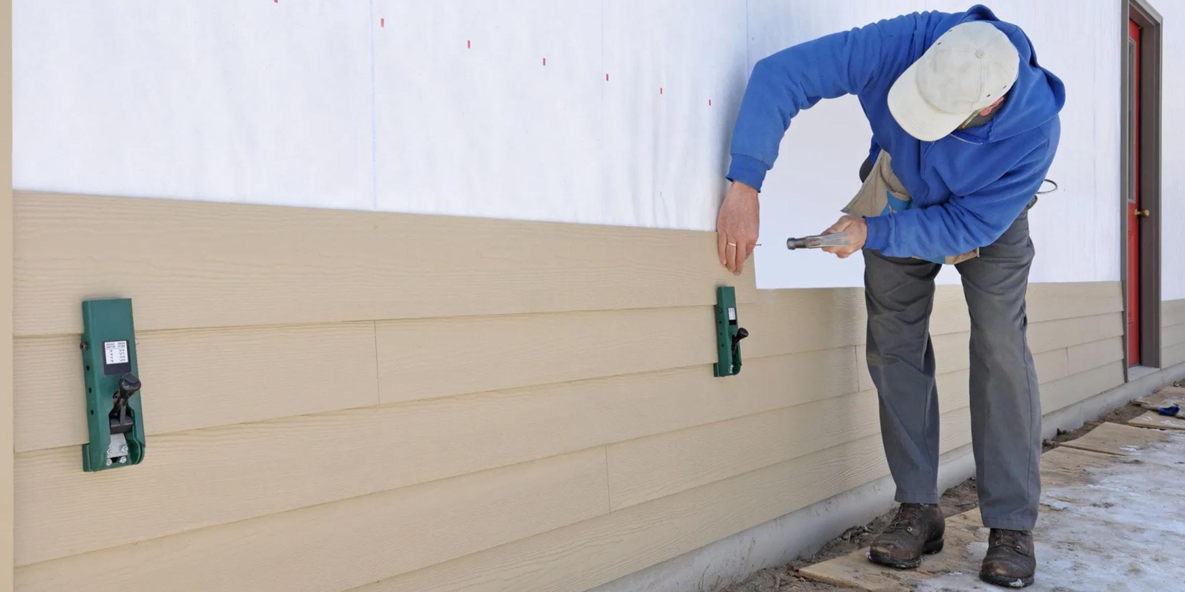 man installing siding with hanmer