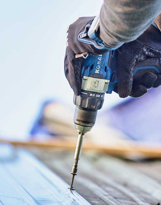 drill being used on metal roof